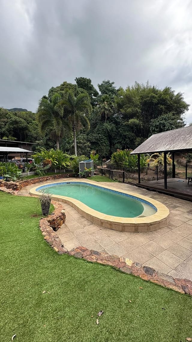 FNQ Clean Up operator pressure washing a residential driveway in Smithfield, north of Cairns